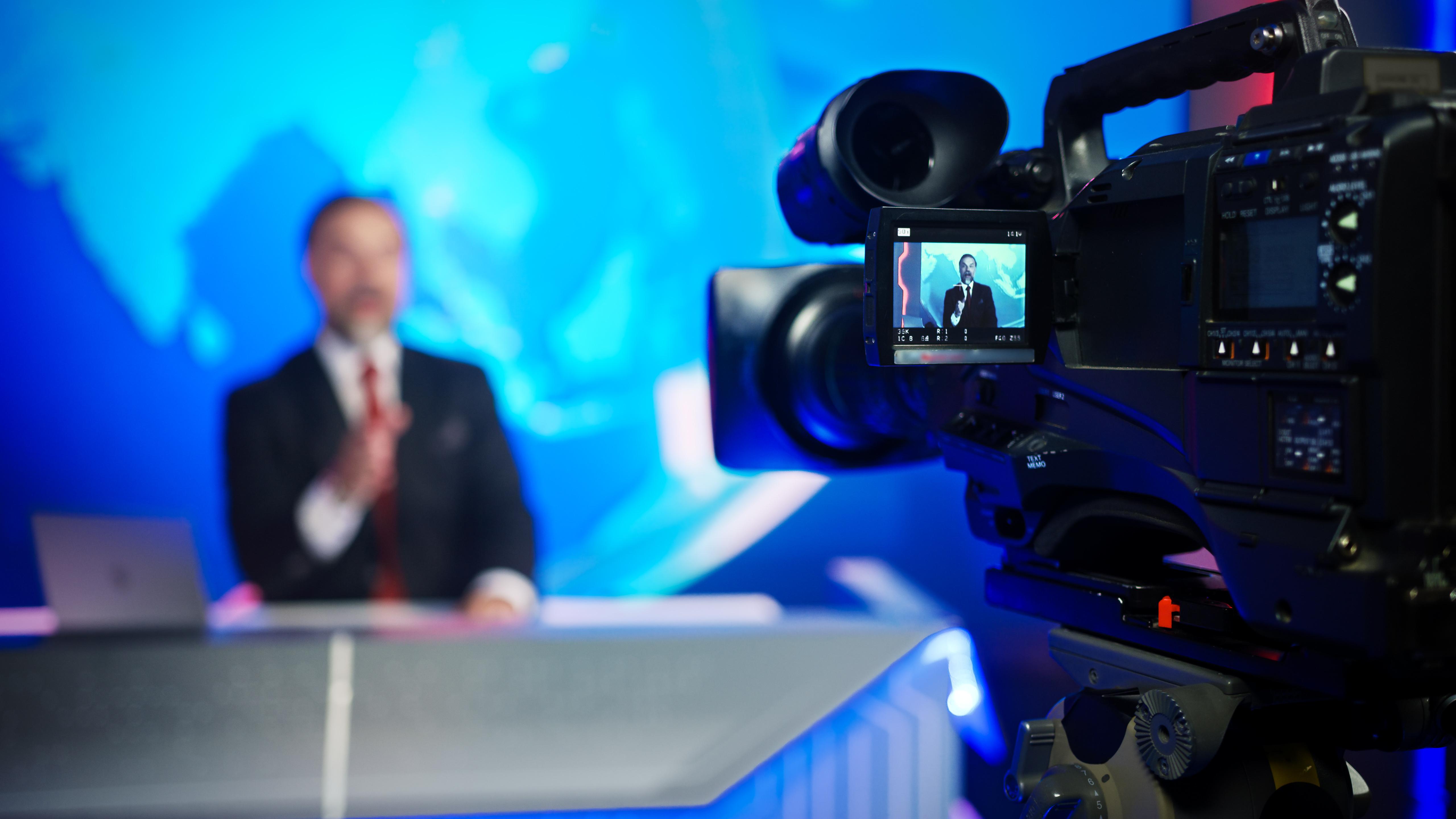 tv news anchorman at his desk