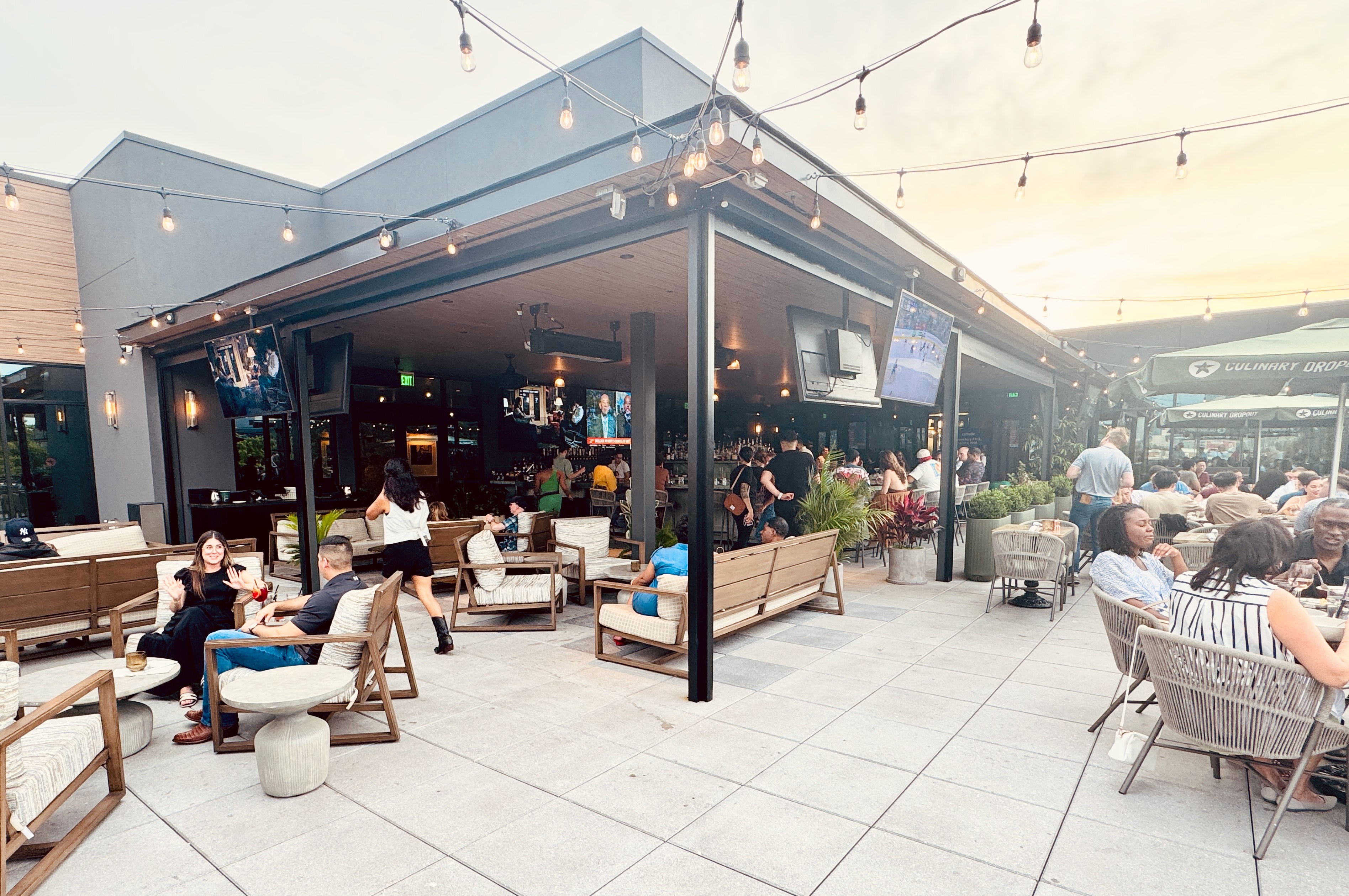 The rooftop at Culinary Dropout with lots of people hanging out and drinking.