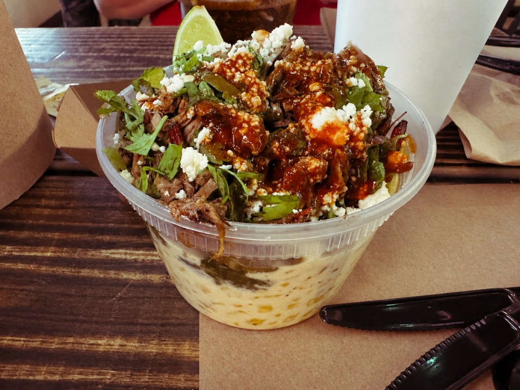 a cup of brisket elotes