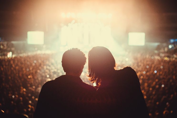 Silhouette of two people at a rock concert