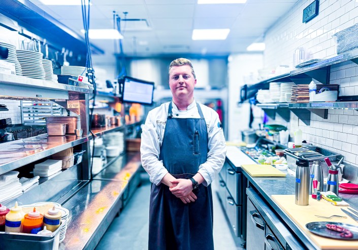 Chef Reilly Brown standing in his kitchen at Frenchie.