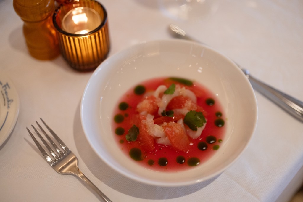 Frenchie's grapefruit hiramasa on a plate on an elegant table.