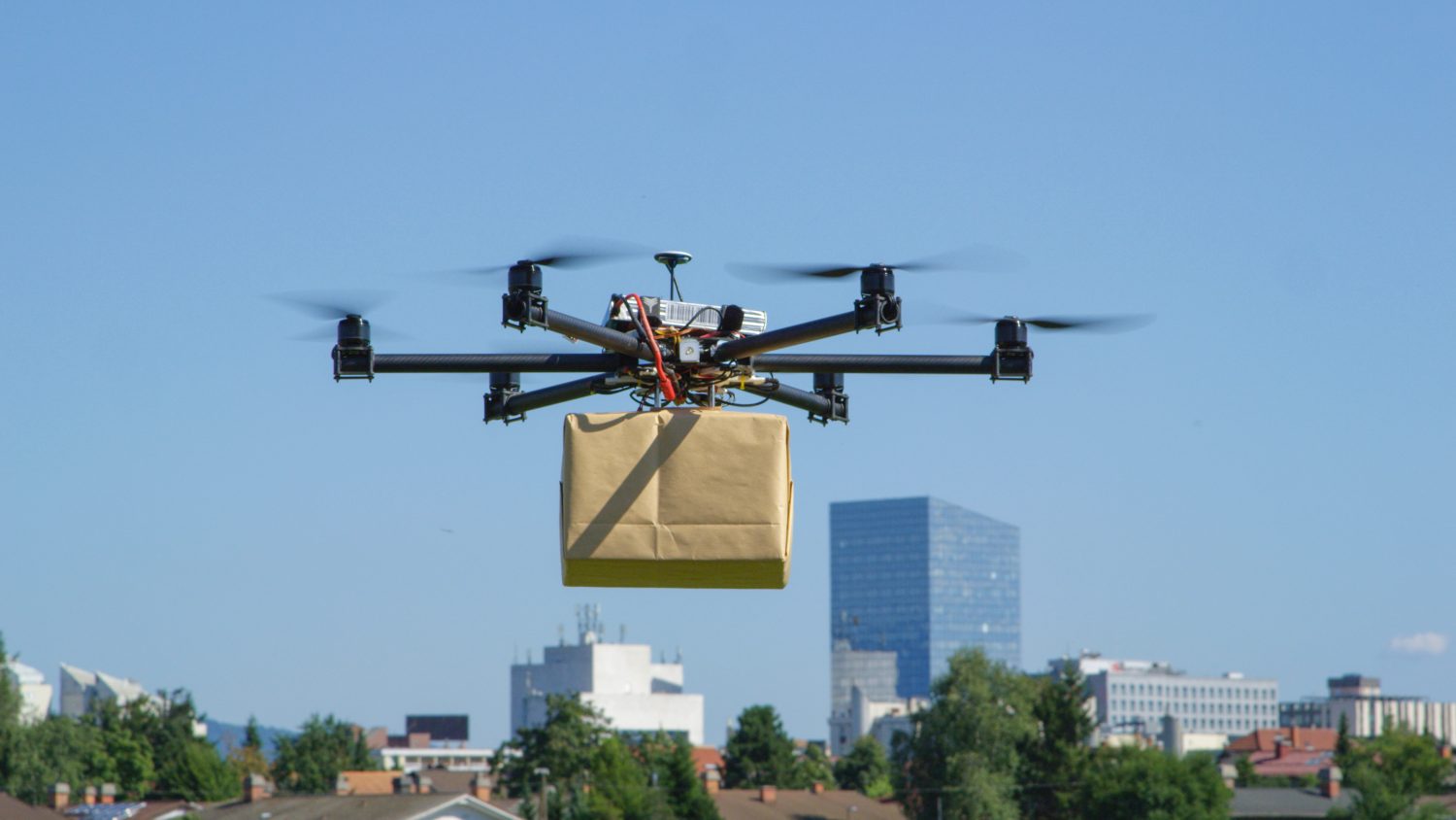 A delivery drone carrying a package through the air