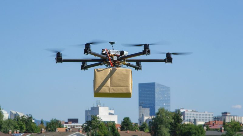 A delivery drone carrying a package through the air
