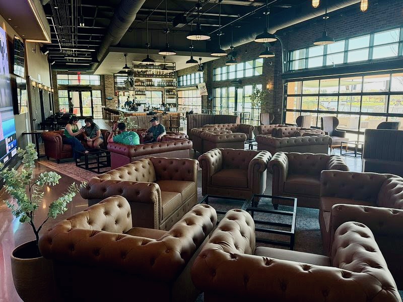 The Landing in Grand Prairie lounge full of brown leather chairs.