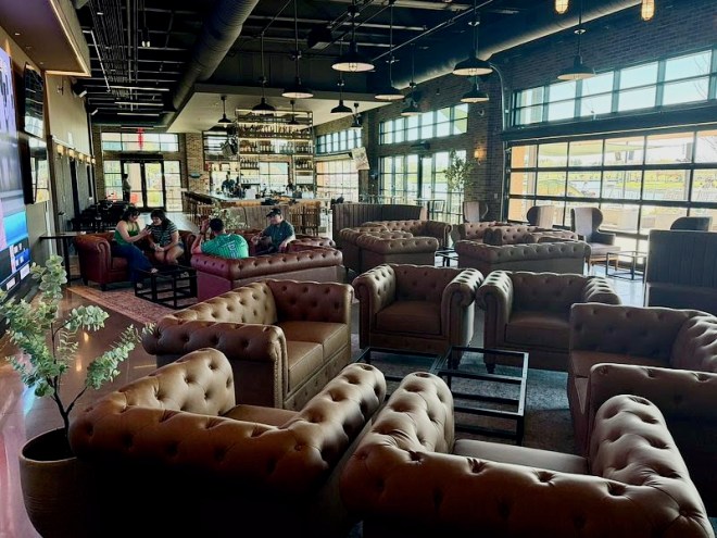 The Landing in Grand Prairie lounge full of brown leather chairs.
