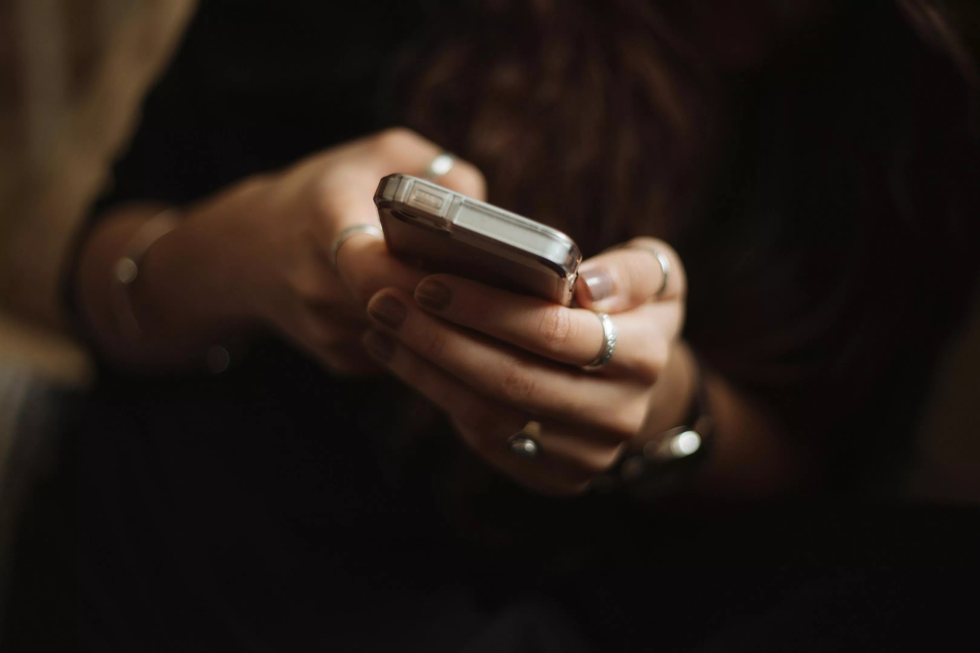 close up on the hands of a person holding a cellphone