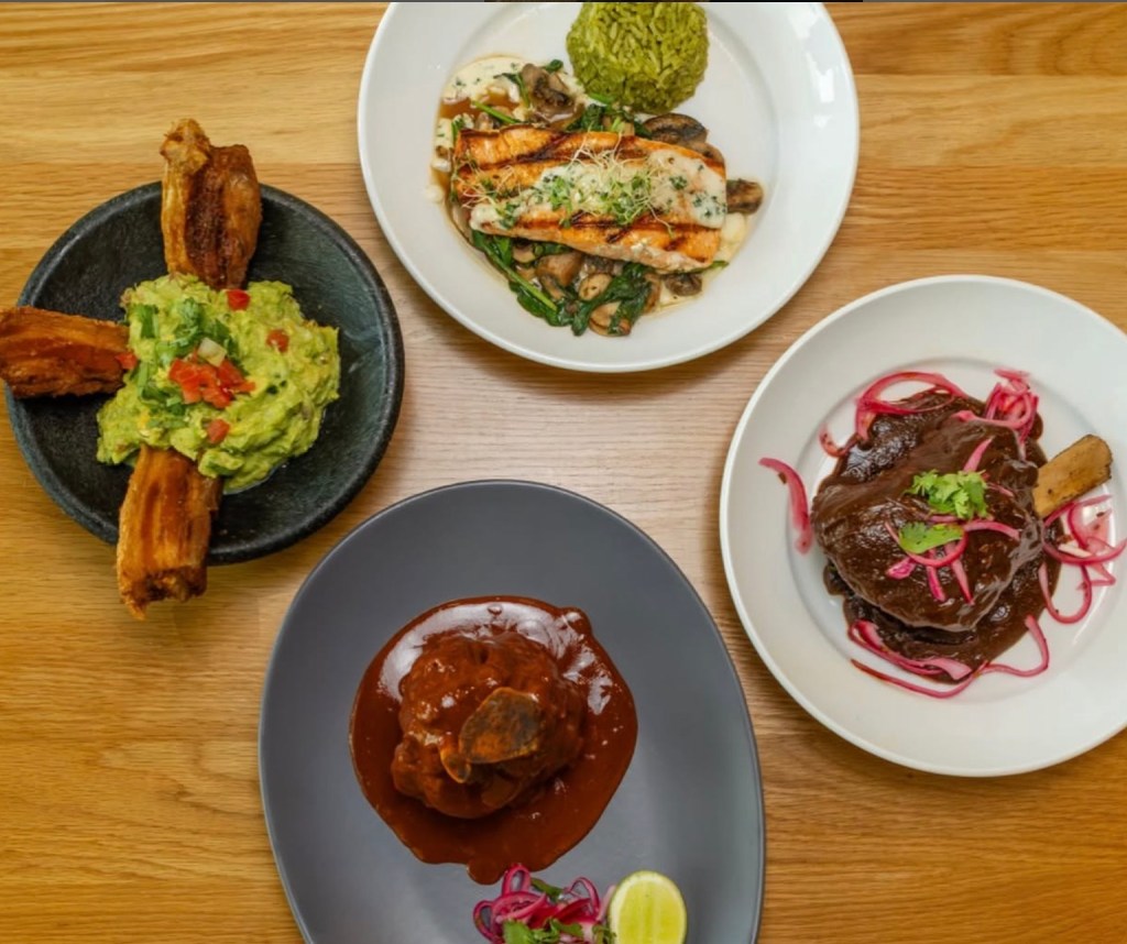 Four plates filled with some of the house specialties at Manny's Mexican Kitchen in Richardson, Texas.