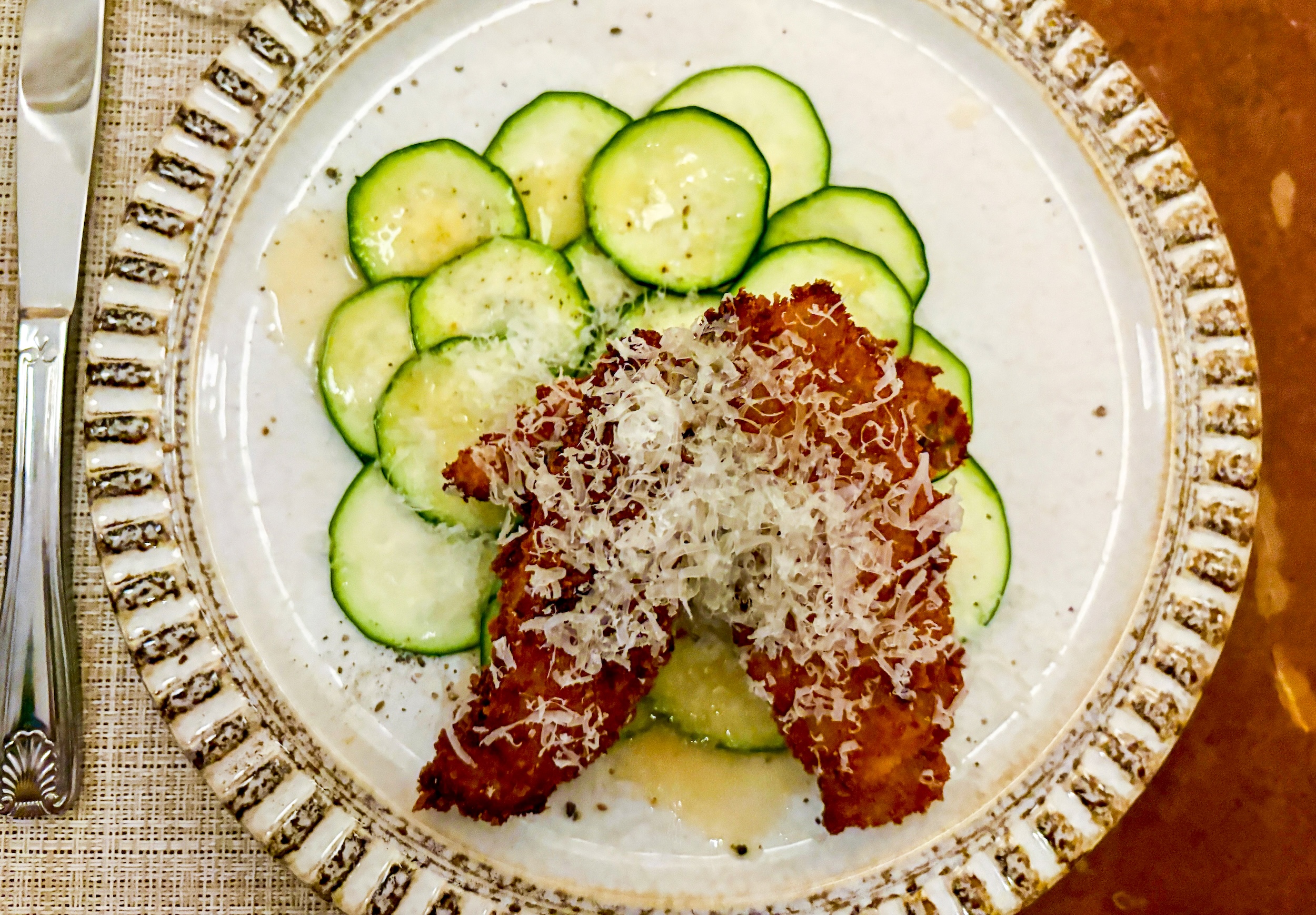 squash blossoms stuffed with house-made ricotta over zucchini carpaccio with a tomato vinaigrette.