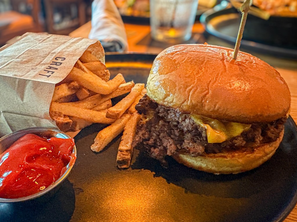 A burger with fries and ketchup