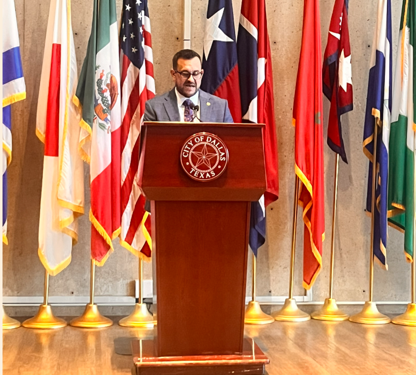 Adam Bazaldua speaks at City Hall against Abbott's threats.