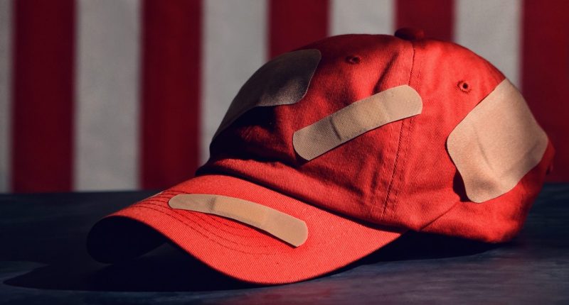 MAGA hat with bandages on it