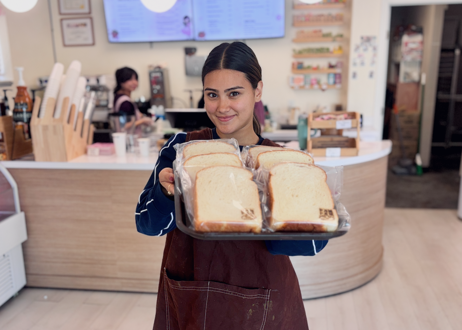 PanPan owner Laura Molinar showing off a pan of her soft bread.