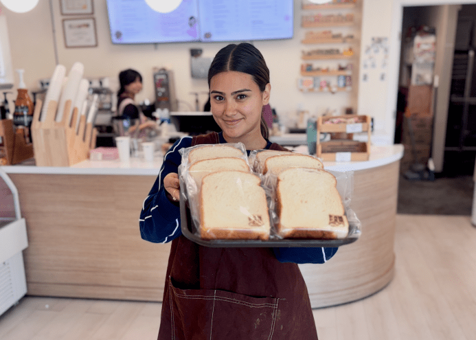 PanPan owner Laura Molinar showing off a pan of her soft bread.
