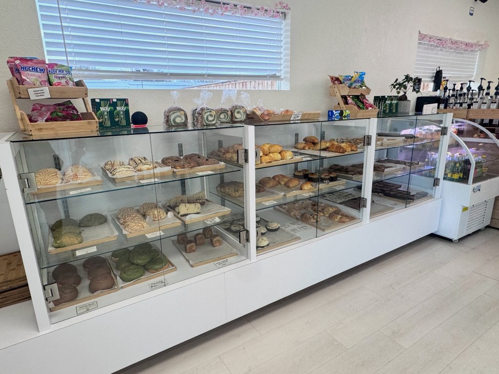 The pastry case at PanPan full of conchas, cookies and milk bread.