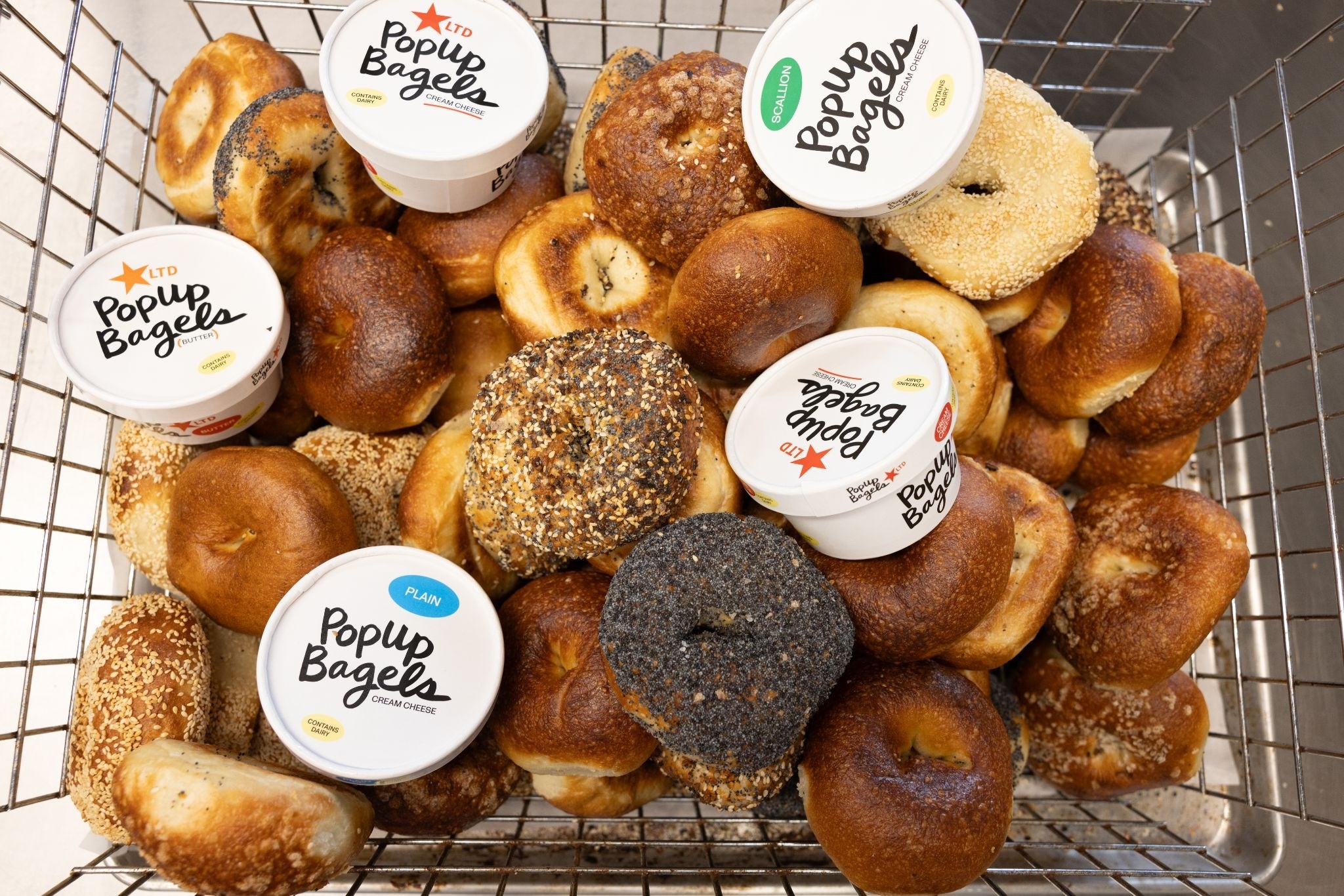 a basket of bagels and schmear from PopUp bagels