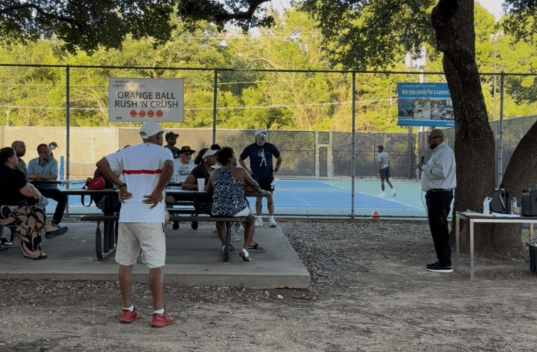 District 4 council member Maxie Johnson addresses community members at a meeting near the tennis courts.