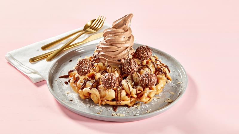 A waffle topped with chocolate and ice cream.