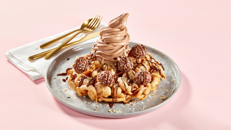 A waffle topped with chocolate and ice cream.