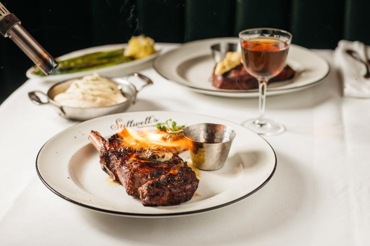 a steak being torhced on a plate at Stillwell's