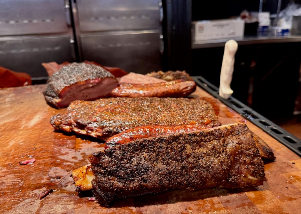 a line of smoked meats at Terry Black's