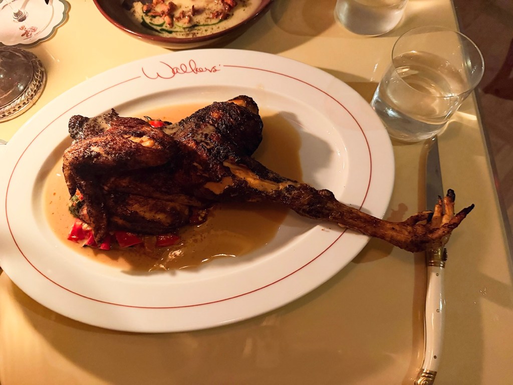 a roasted quarter chicken with feet on