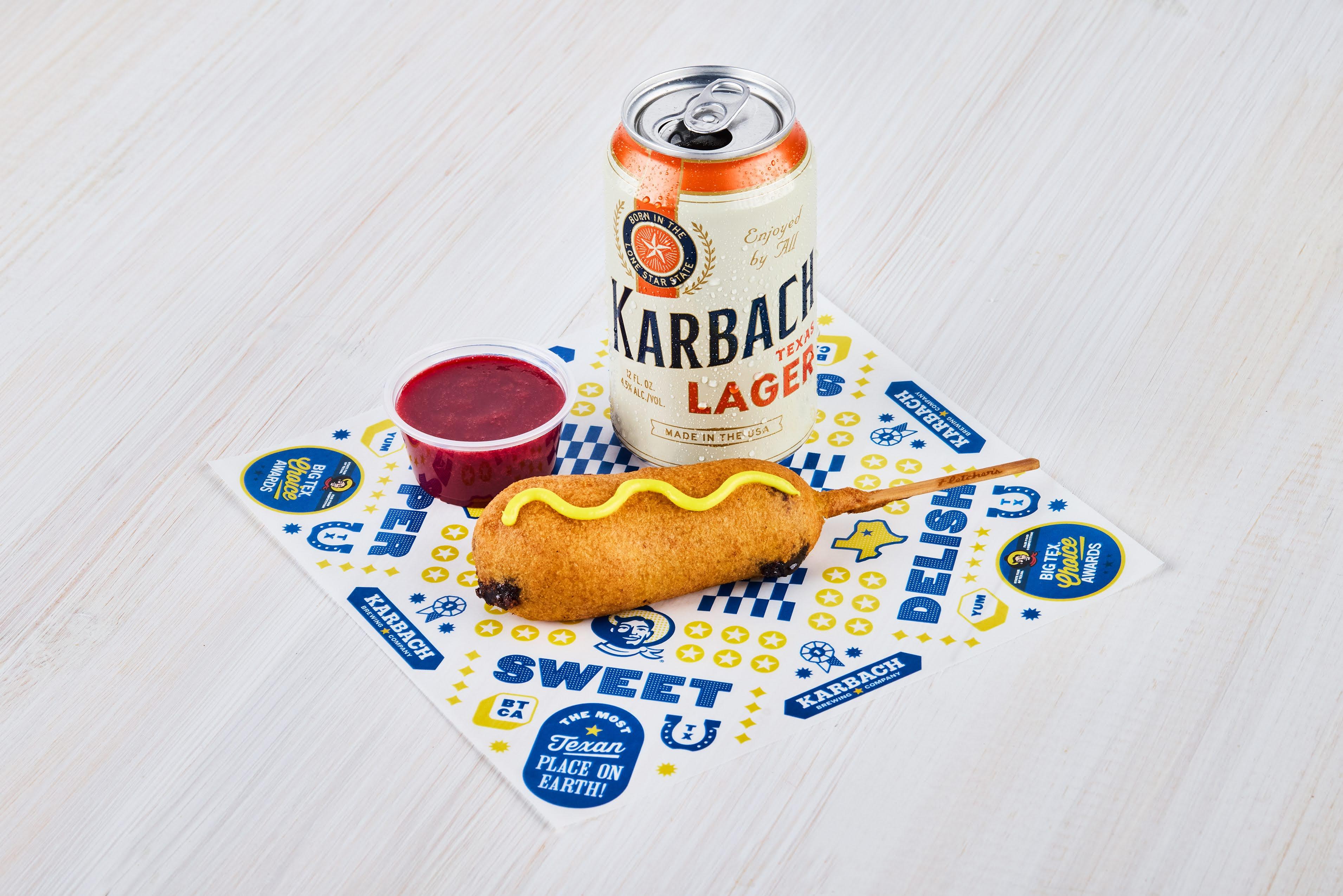 a corn dog with raspberry compote and a beer