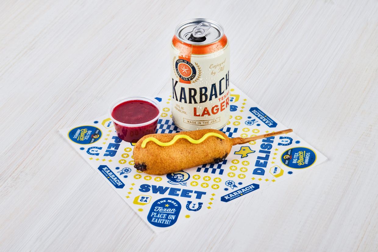a corn dog with raspberry compote and a beer
