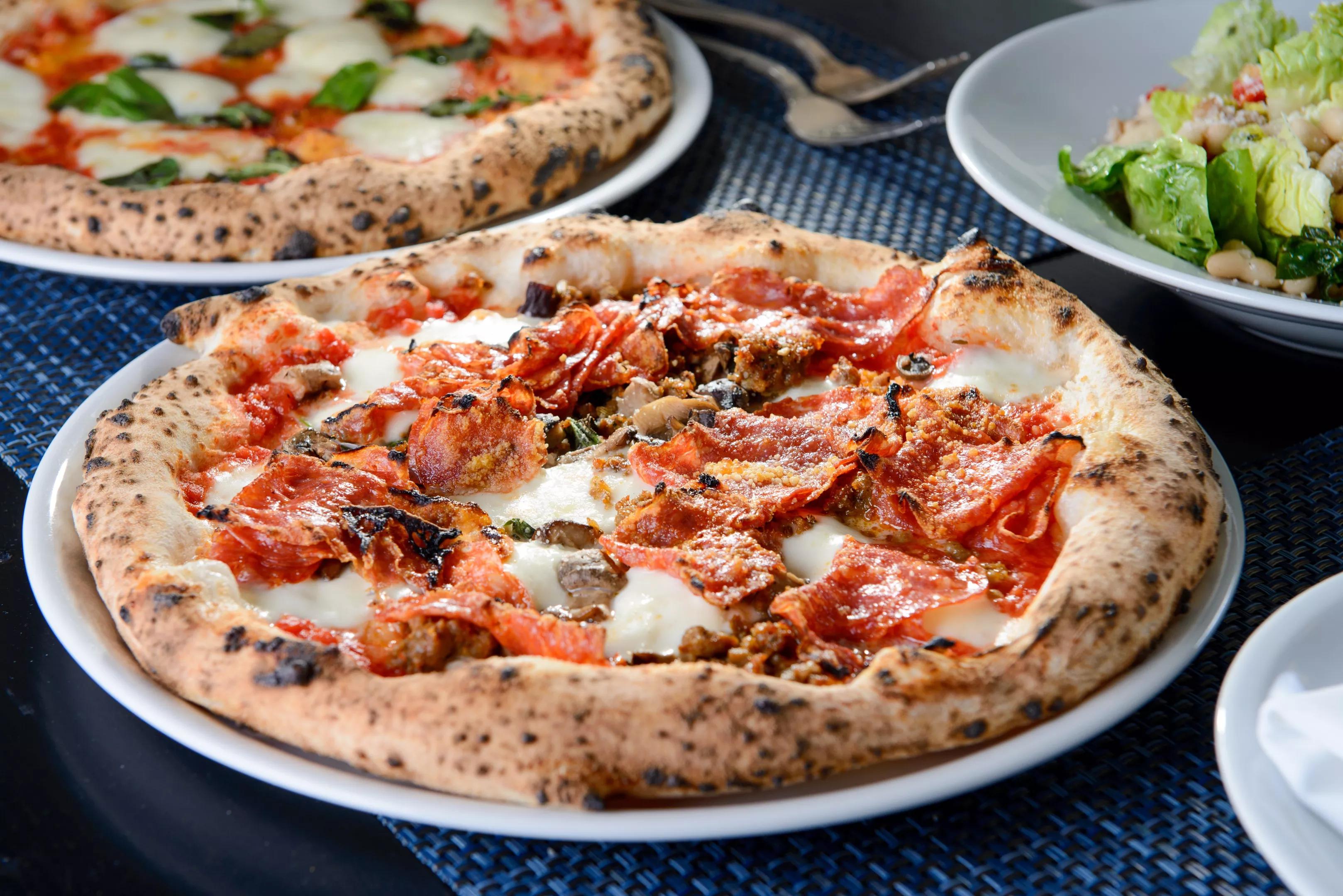 Pizza at Partenope with mozzarella, pecorino, tomato sauce, soppressata, Jimmy's sausages, mushrooms and basil.
