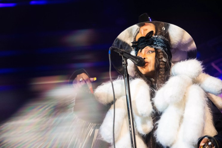 Erykah Badu in a white fur coat, celebrating her birthday bash in her signature mirrored top hat back last February at The Factory.