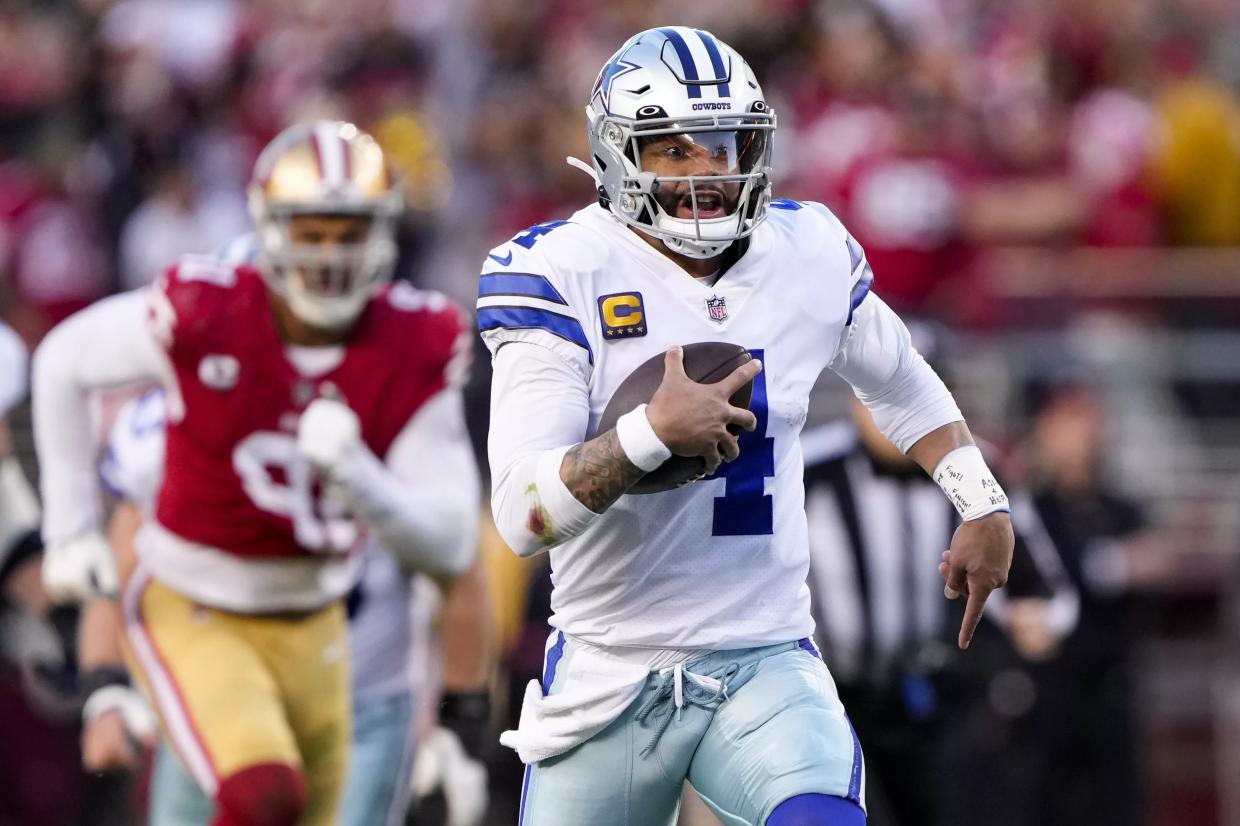 Dak Prescott runs while playing with the Dallas Cowboys, which have a new friend back in Jimmy Johnson.