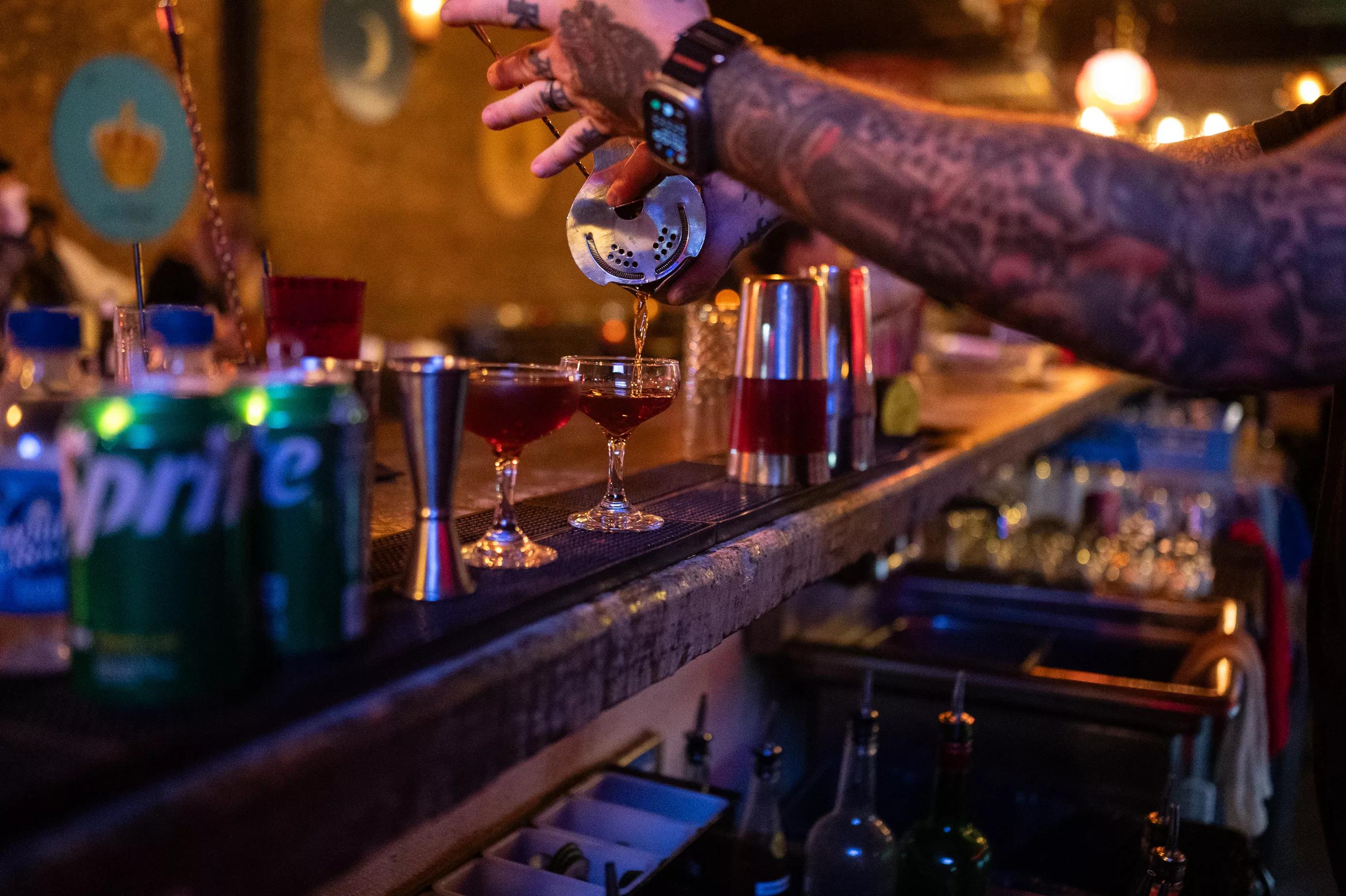 A bar tender pouring a drink