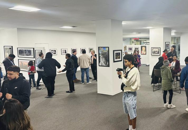 Patrons check out art at A Decisive Vision: New Perspectives from Dallas College Faculty and Students, on display at the Adolphus Tower Gallery through March 29.