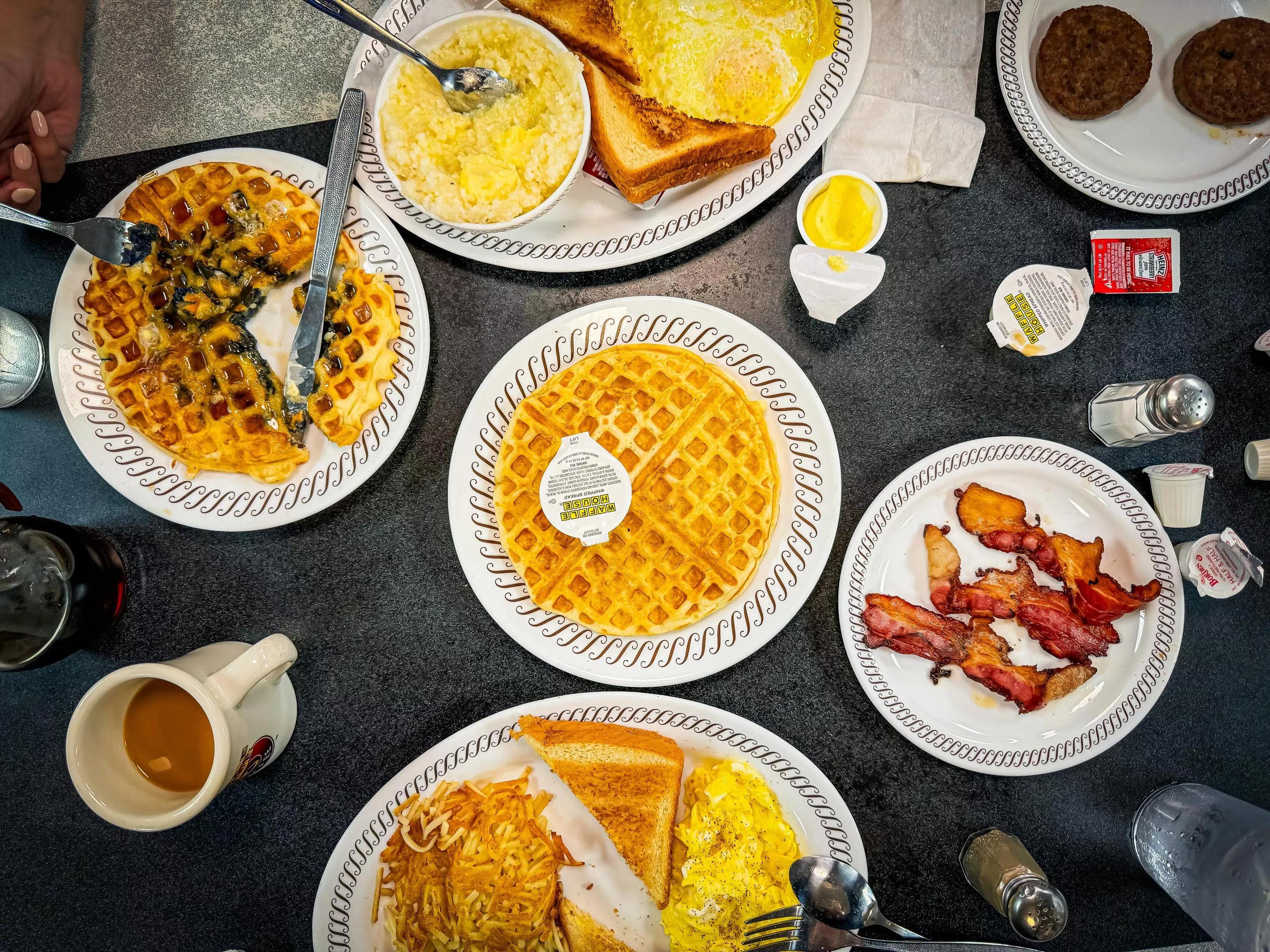 Waffle House table full of food.