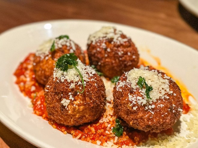a plate of Cacio e pepe fritters at Seager and Sons