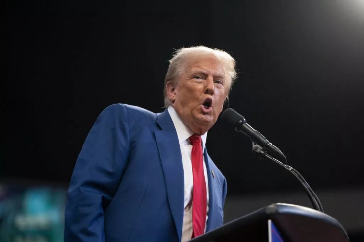 Donald Trump speaking into a microphone
