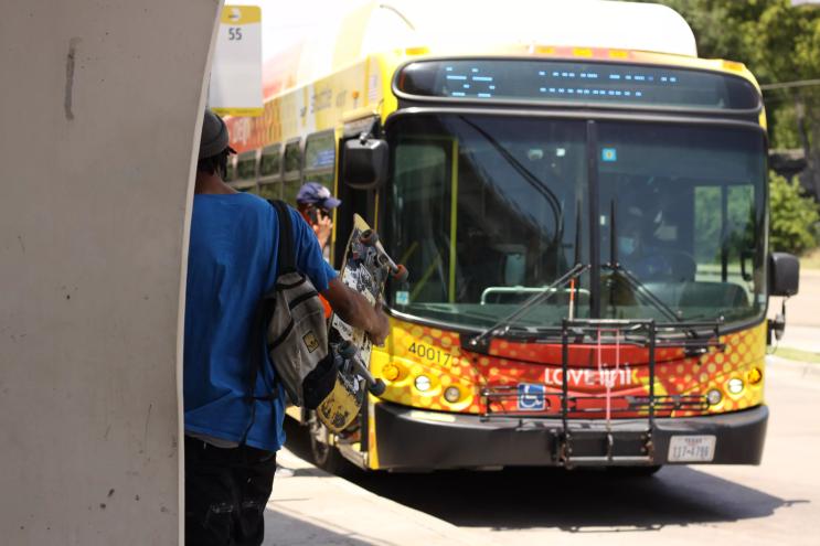Riders board a DART bus.