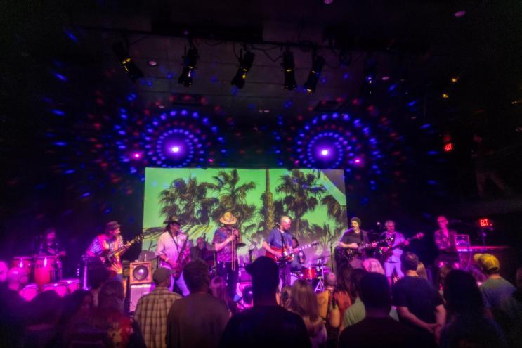 A group of musicians and band members on stage