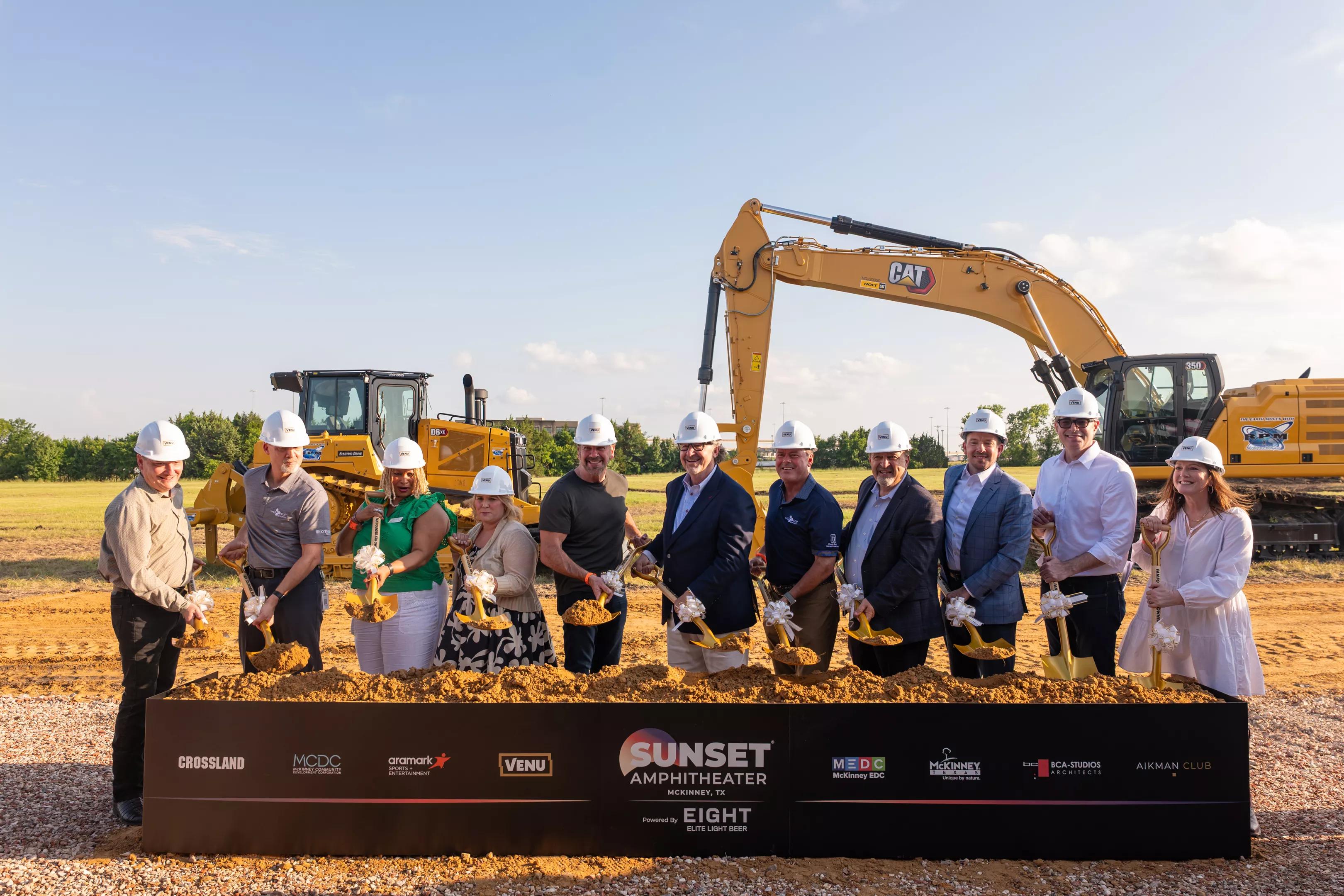 A group of people in front of dirt