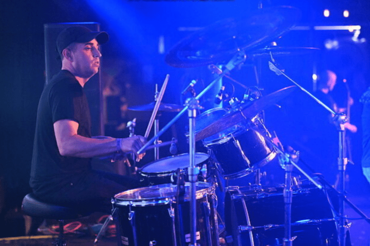 Man drumming on stage
