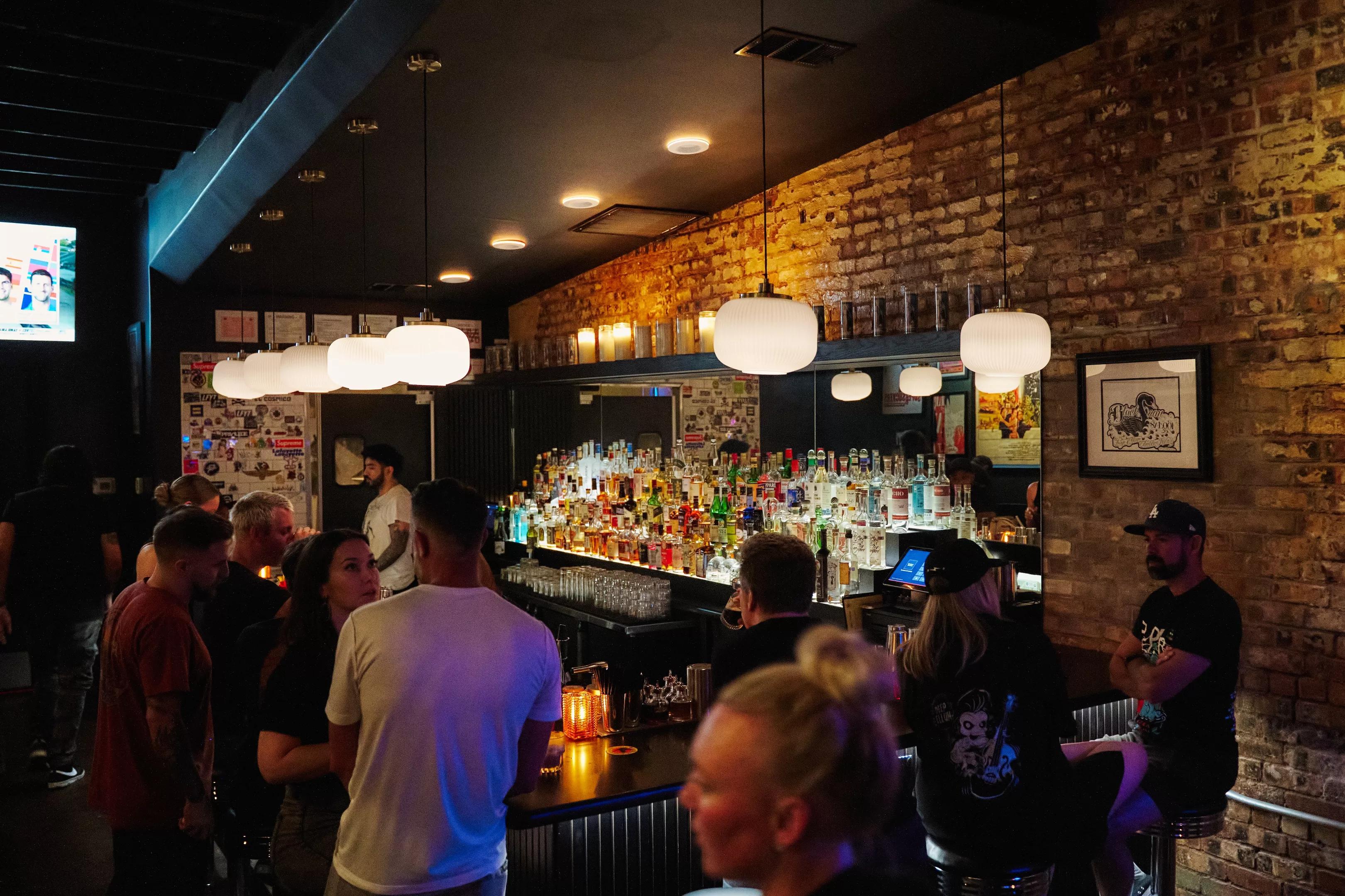 a crowd at The Black Swan Saloon