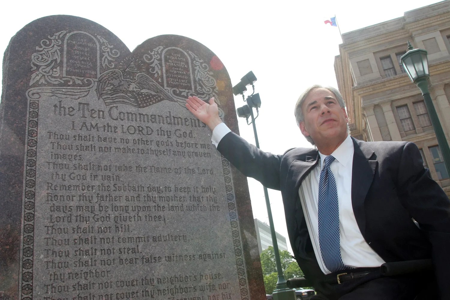 Greg Abbott in front of a statue of the Ten Commandments