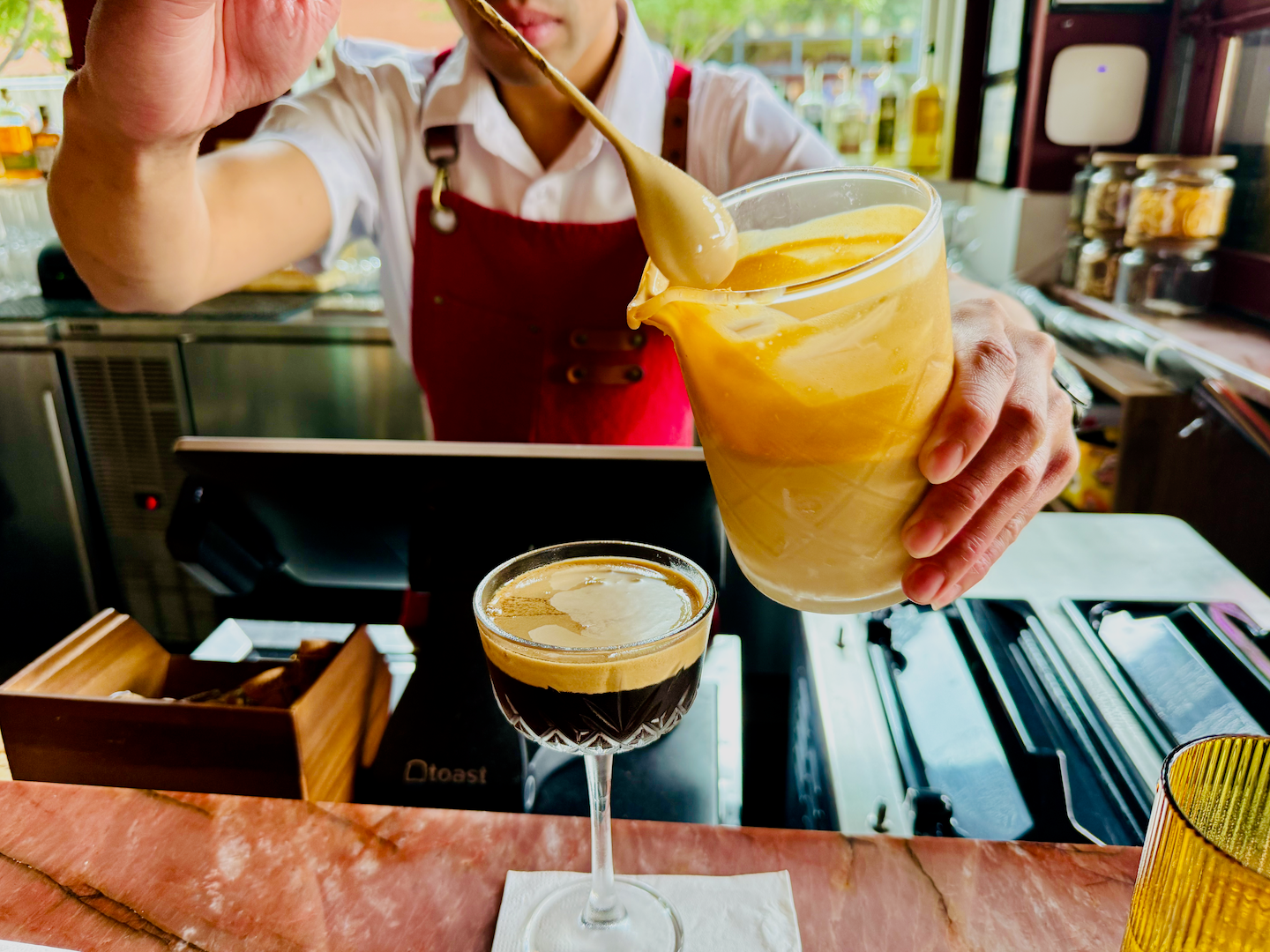 An espresso martini being made by a bartender at the restaurant Flamant.