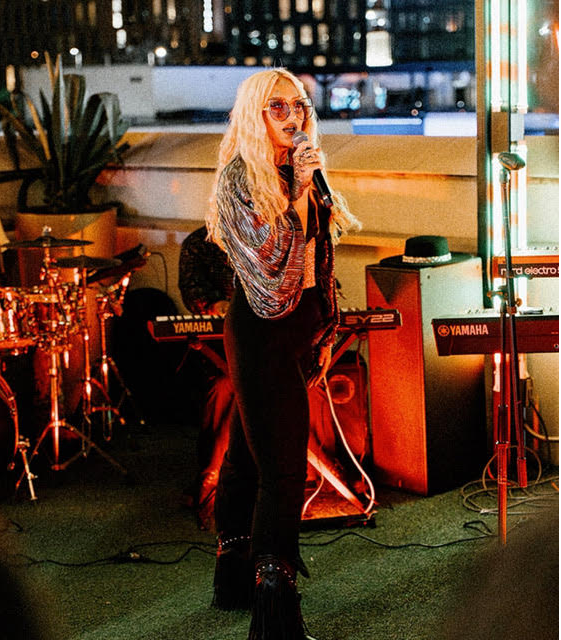 A woman hosting an open mic